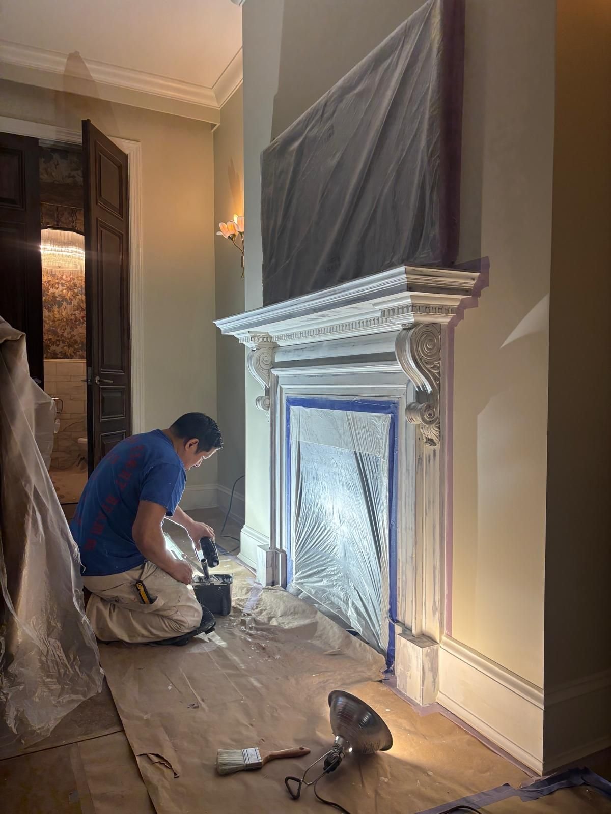 Lvl 5 painter doing detail work on a fireplace mantel