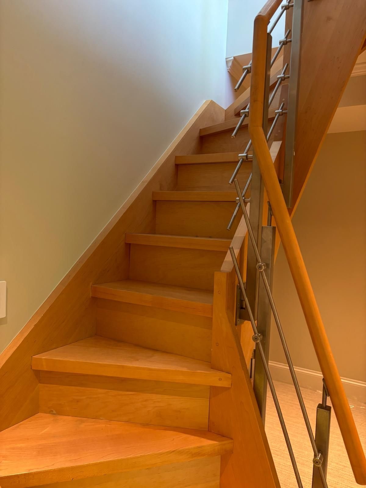 Fresh wall paint along a wood staircase